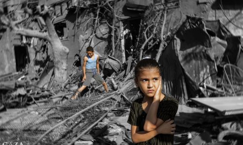 TOPSHOT - A girl looks on as she stands by the rubble outside a building that was hit by Israeli bombardment in Rafah in the southern Gaza Strip on October 31, 2023 amid ongoing battles between Israel and the Palestinian Hamas movement. (Photo by MOHAMMED ABED / AFP) (Photo by MOHAMMED ABED/AFP via Getty Images)